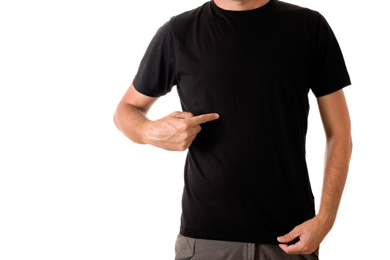Man in black T-shirt pointing to his chest.